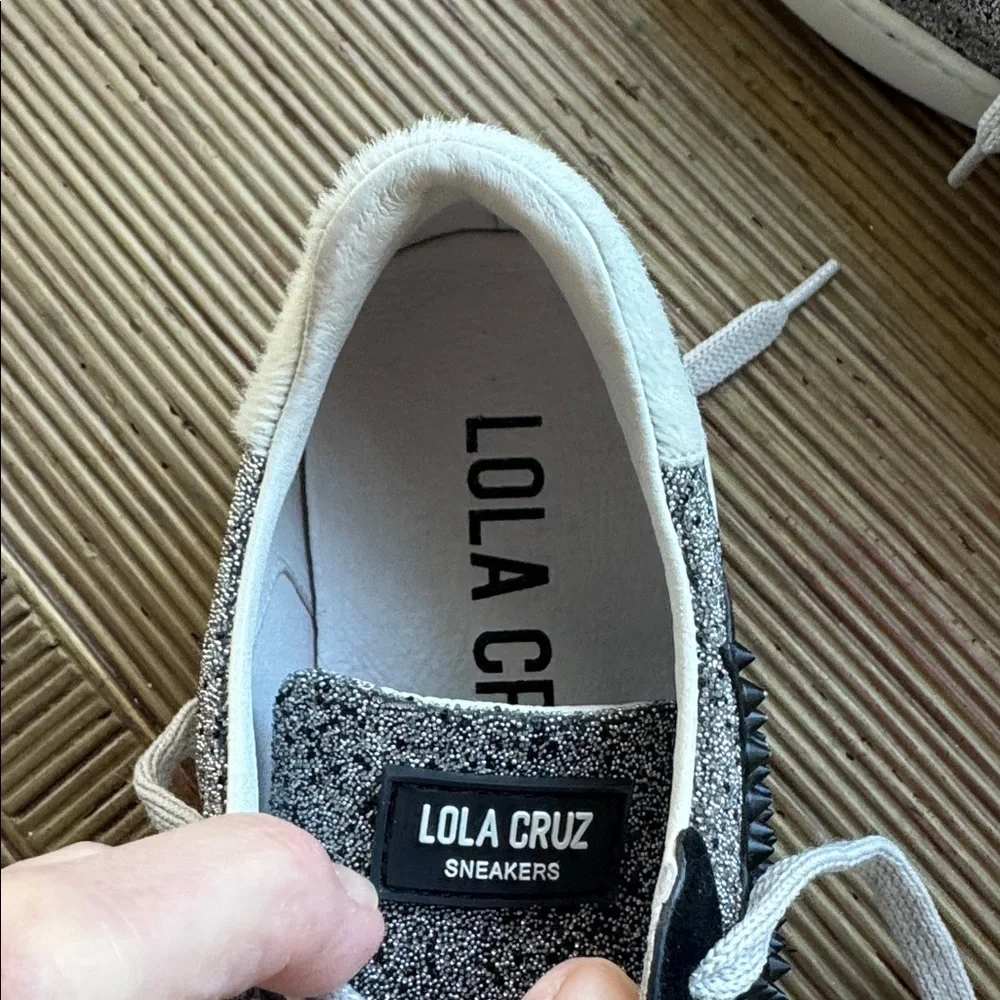 Lola Cruz silver metallic sneakers with a black raised star